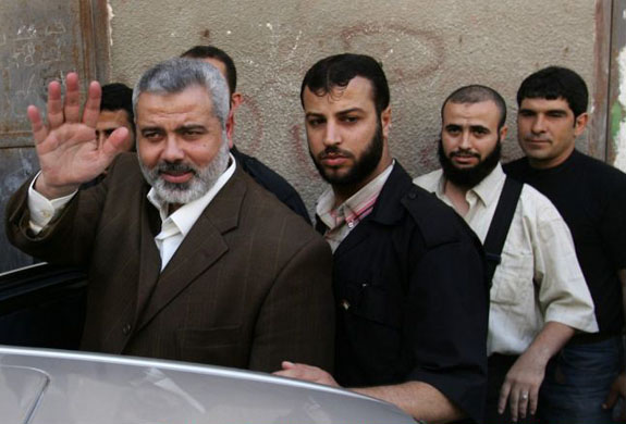 Hamas leader Ismail Haniyeh (2ndL) arrives to meet Palestinian engineer Salem Sabra who was released by Hamas in Gaza