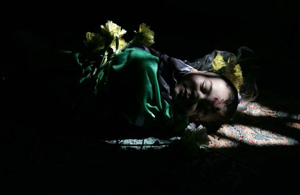 The body of five-month old Mohammad Naser Al-Buri lies at the mosque during his funeral in Gaza