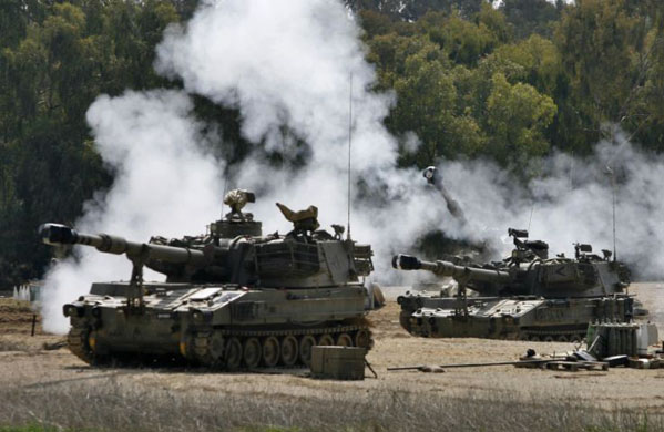 An Israeli mobile artillery unit fires from a position outside the Gaza Strip