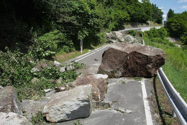 A road is blocked by a landslide caused by an earthquake in Kurihara