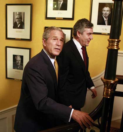 The prime minister walks up the Downing Street stairs with George Bush