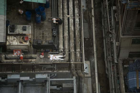 A workers sleeps on the roof of one Hong Kong's restaurants