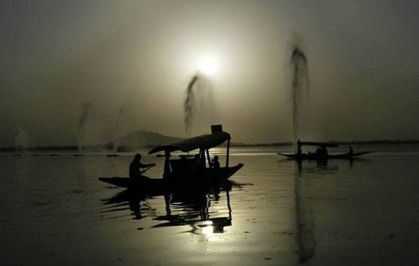 Srinagar, India: Tourists enjoy a boat ride on Dal Lake