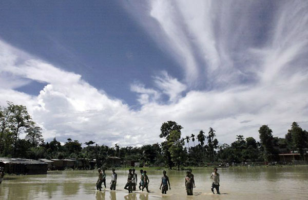 North Lakkhimpur, India: Villagers wade through floodwaters