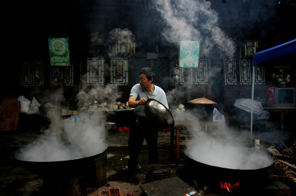 Dujiangyan, China: A Muslim cooks dinner at the Dujiangyan Mosque which was seriously destroyed in the earthquake