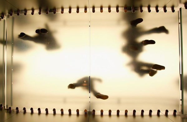 Sydney, Australia: Apple customers walk across a translucent floor during the offical opening of the new store