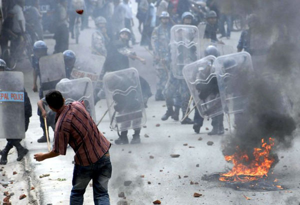 Kathmandu, Nepal: Policemen clash a with agitating students during a protest against the price hike in fuel and transportation