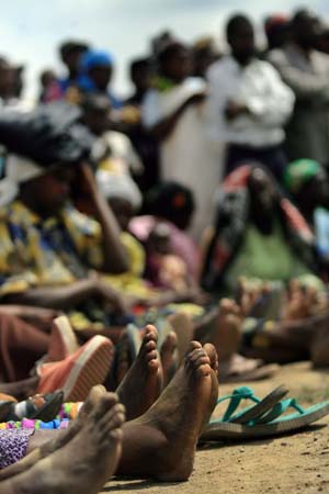 Internally displaced persons gather to listen to the visiting UN High Commisssioner for Refugees