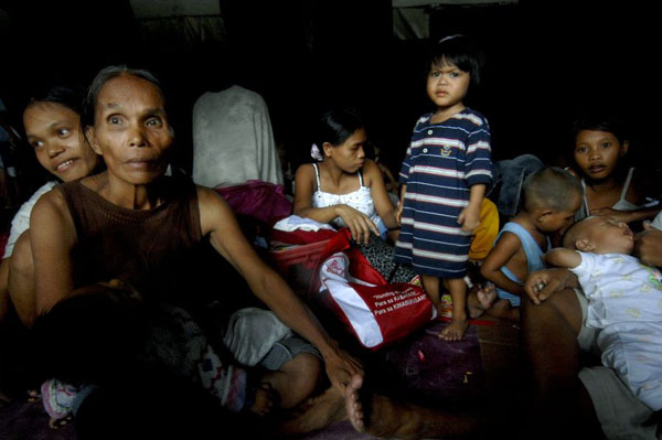 Tondo, Manila: Evacuees from poor families living in a slum after being evacuated and housed in military tents after Typhoon Fengshen hit the country