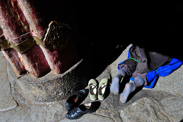 Lhasa, Tibet: A Tibetan woman praying at Jokhang temple