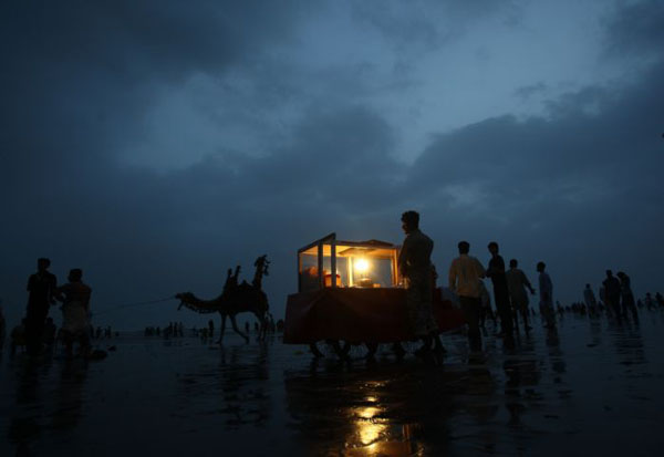 Karachi, Pakistan: People visit Clifton beach during cloudy weather