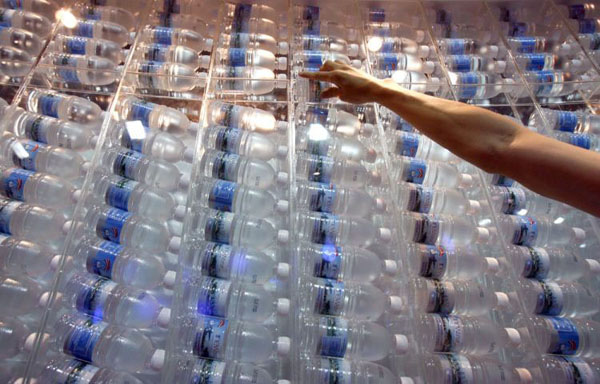 Singapore: A worker stacks bottles of processed water on display at an exhibition booth during International Water Week