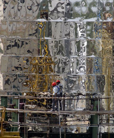 Kalpakkam, India: Construction workers check the position of a nearly 200 ton nuclear reactor safety vessel