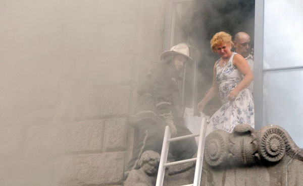 Kiev, Ukraine: A firefighter evacuates employees from the city state administration building