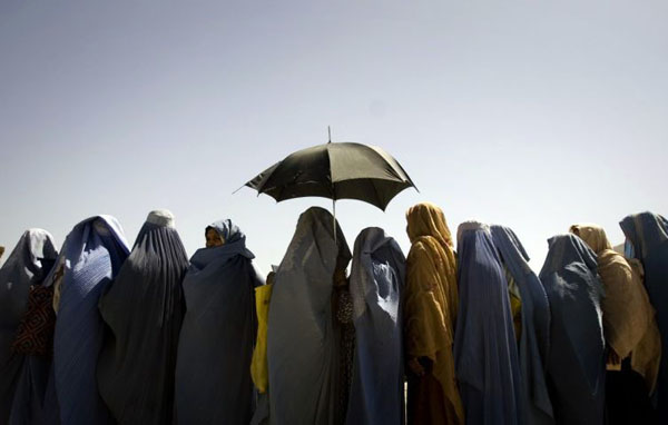 Kabul, Afghanistan: Widows line up as they wait for their monthly food ration