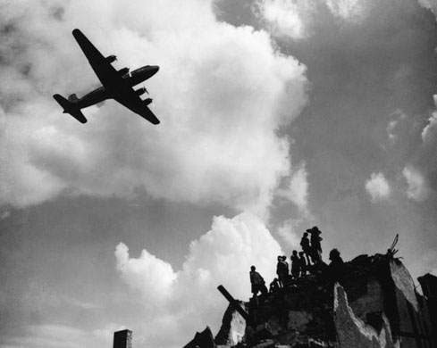 Youngsters stand on a bomb-damaged building near the Tempelhof Airport