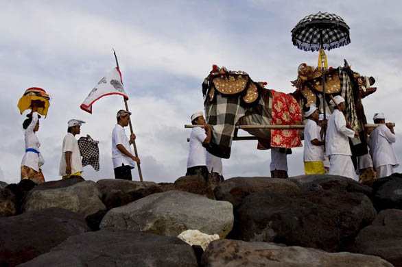 Sanur, Bali: Hindu devotees carry a 'Pratima' symbol of God during a cleaning ceremony called 'Melasti'