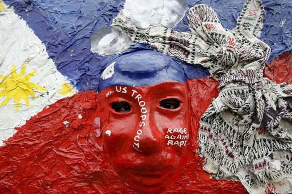 A protester wears a mask in a rally demanding justice for a   Filipino woman allegedly raped by an American soldier in Japan