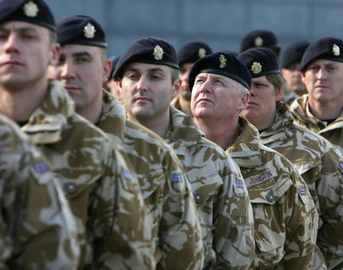 Soldiers stand in line before marching towards City Hall where they will receive medals for their achievements in Afghanistan