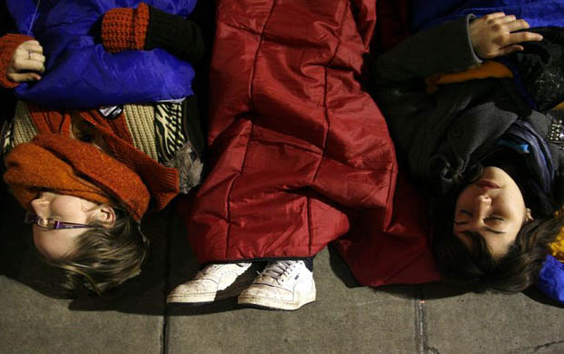London, UK: Students lie on the ground at St Paul's Church in Covent Garden