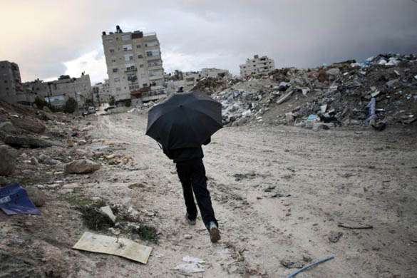 Jerusaleam: A young bedouin walks past a trash dump in the Shoafat refugee camp