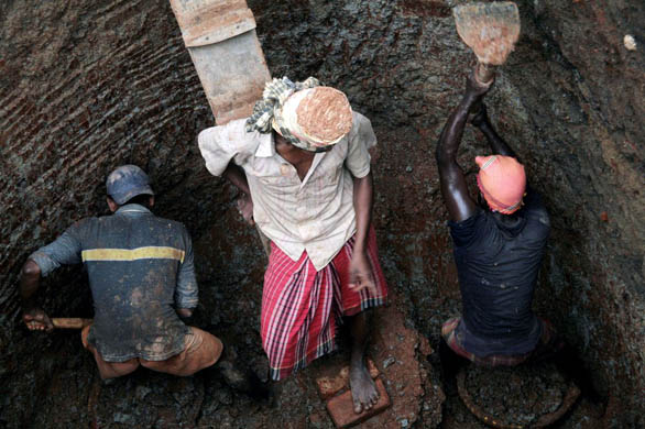 Dhaka, Bangladesh: Construction workers dig a twenty-foot well on the edge of the university campus