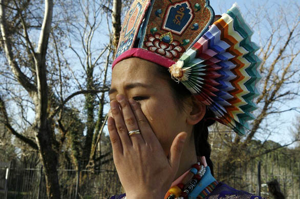 A Tibetan protester during a symbolic flame ceremony