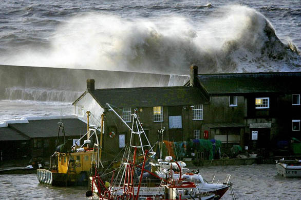 Lyme Regis, Dorset: Fishing vessels take refuge within the walls of the historic Cobb