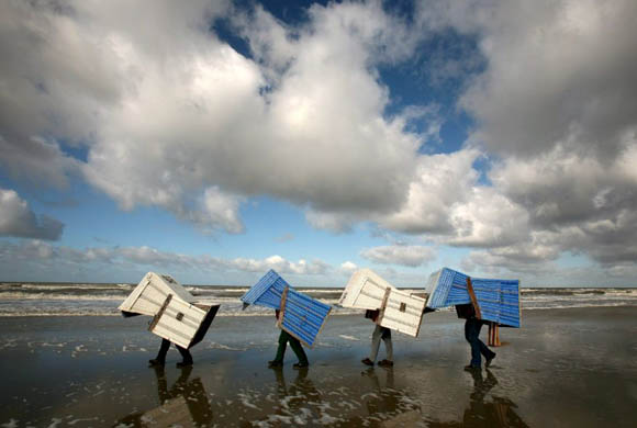 St Peter-Ording, Germany: People carrying beach chairs ready for Easter tourists
