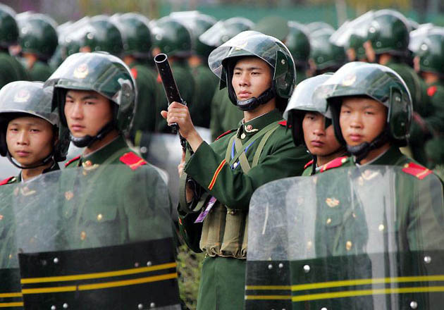 Paramilitary police guard the team buses after the World Cup soccer qualifying match between Australia and China