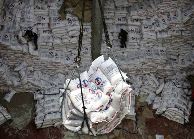 Manila, Philippines: Workers arrange sacks of rice imported by the Philippine National Food Authority