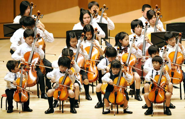 Tokyo, Japan: Children and advance students from the Suzuki Method music school play the cello