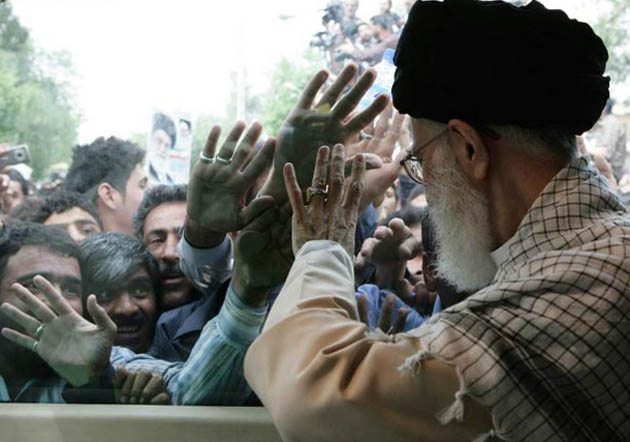 Iran's Supreme Leader Ayatollah Ali Khamenei waves to the crowds 