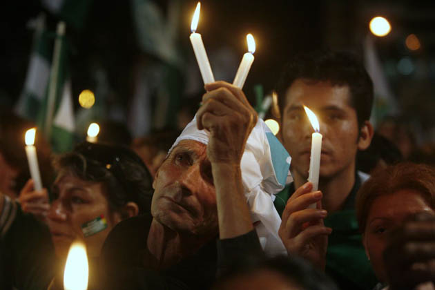 Residents, holding up candles, demonstrate during the closing campaign rally in support of a provincial referendum for autonomy