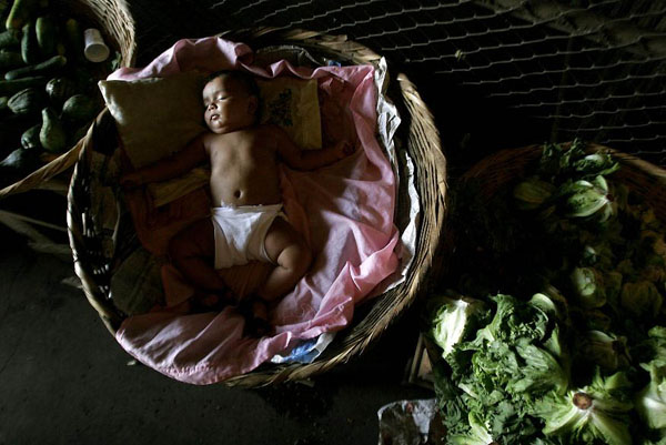 El Mayoreo, Managua: A baby sleeps inside a basket at the market
