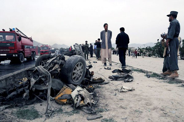 Kabul, Afghanistan: Police officers inspect the wreckage of a vehicle used in a suicide bomb attack