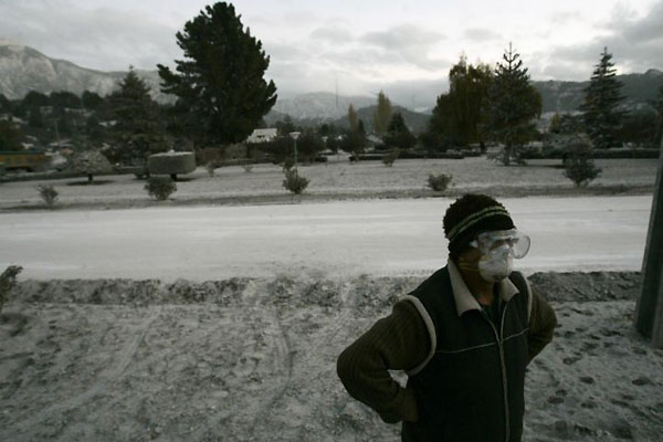 Futaleufu, Chile: A resident stands at a street covered in ashes