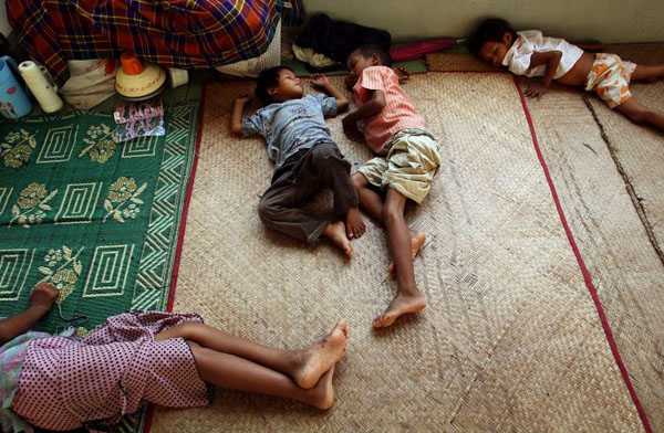 Kyacek Tan, Myanmar: Infants sleep on the floor of a refugee camp