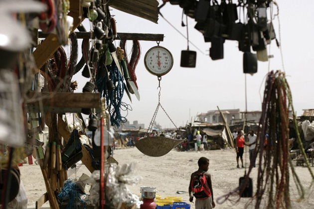 A child walks past a hardware store at the slum of Cite Soleil
