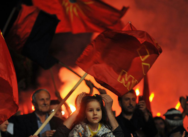 Supporters with party flags cheer Prime Minister Nikola Gruevski