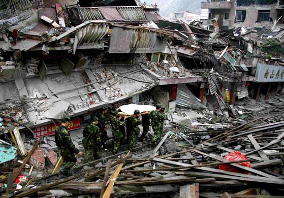 Rescuers carry a survivor away