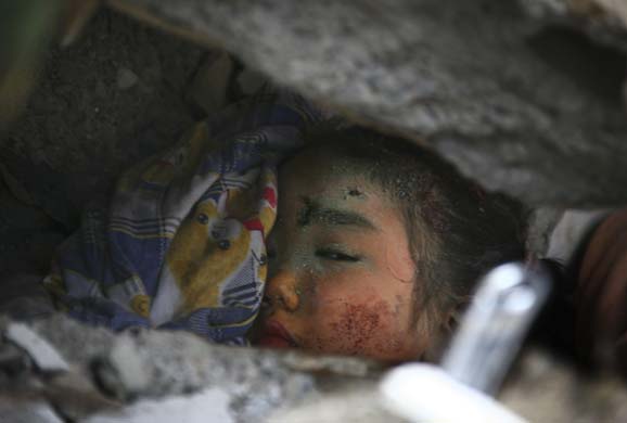 A child is trapped in the rubble