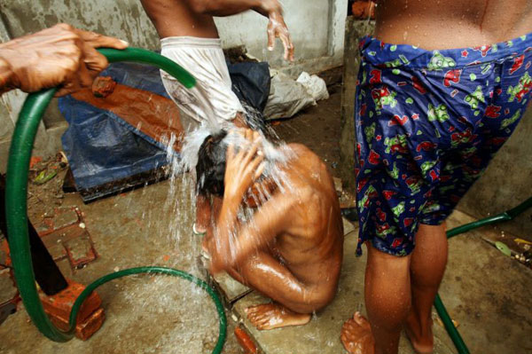 Maubin, Myanmar: People from a refugee camp wash at a private house that donated water for refugees