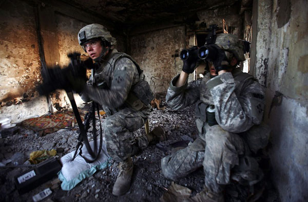 Baghdad, Iraq: US army soldiers look for a location of a sniper at a patrol base in the Shiite enclave of Sadr City