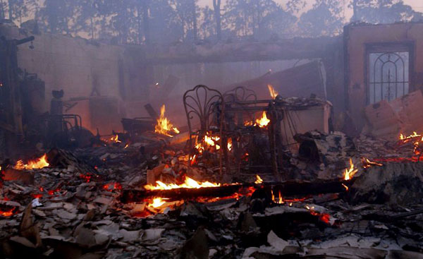 Palm Bay, US: Furniture in the shell of a burned out home after wildfires rolled through the area