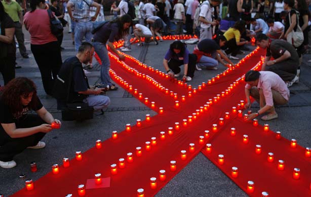 People lighting candles