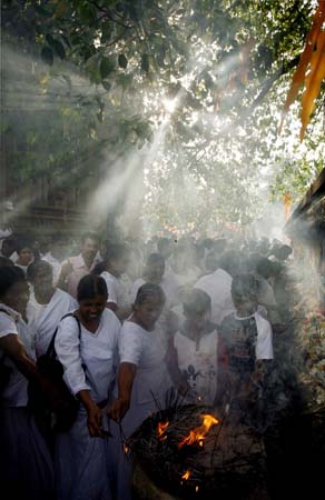Buddhists light incense