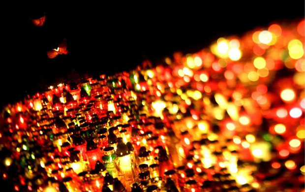 Gdansk, Poland: Candles burn at the Srebrzysko Cemetery on All Saints Day 