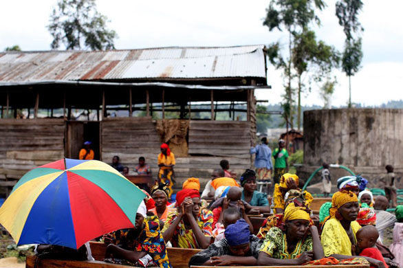 Goma, Democratic Republic of Congo: Women sit on benches during a church service in an Internally Displaced People (IDP) camp