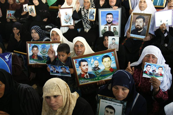 Gaza City: Palestinians hold pictures of their relatives held in Israeli jails during a protest calling for their release